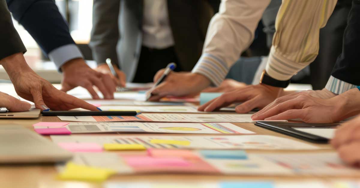 A group of business professionals gathered around a conference table, discussing and brainstorming future company strategies.